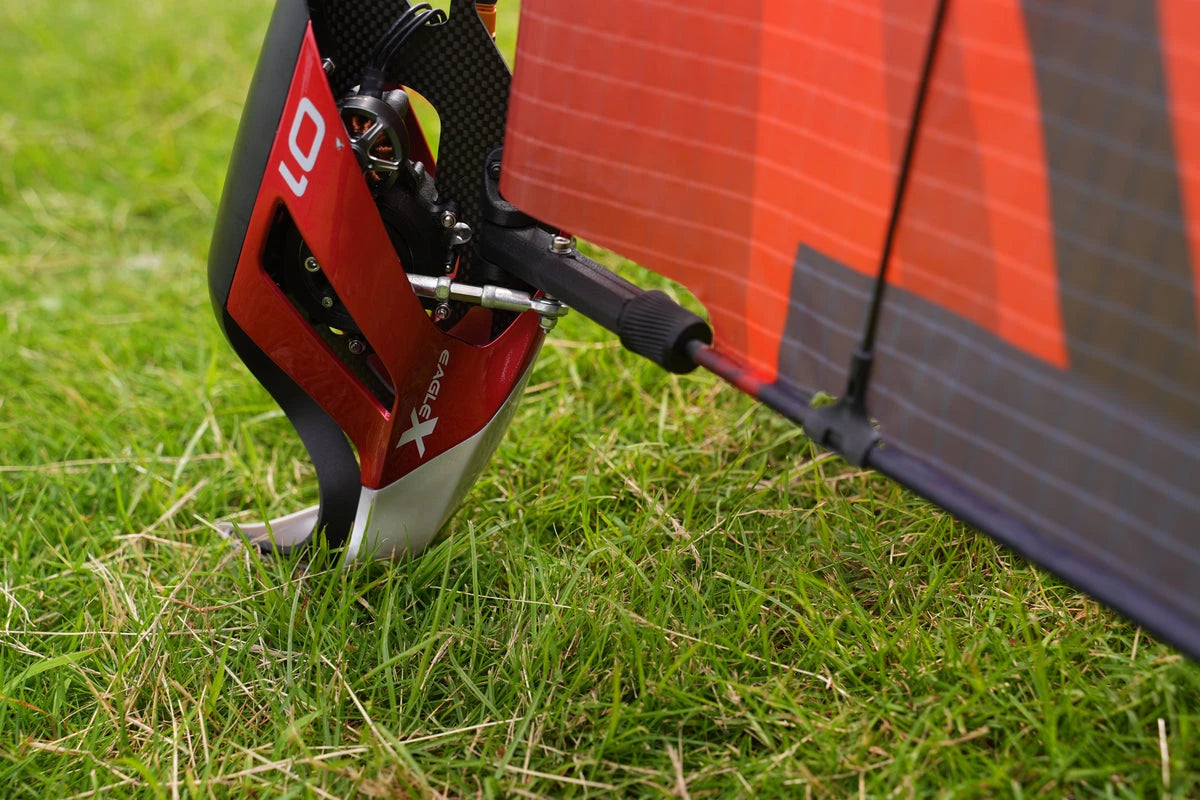 EAGLE X wing and fuselage structure resting on grass